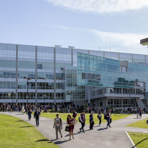 SFSU campus building with lots of students outside