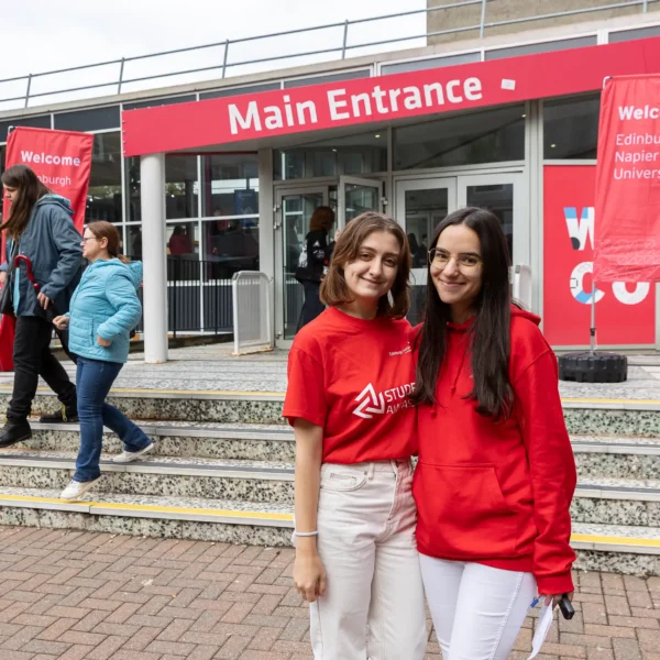 Friendly student ambassadors greeting new students and visitors at Edinburgh Napier University’s main entrance during open day