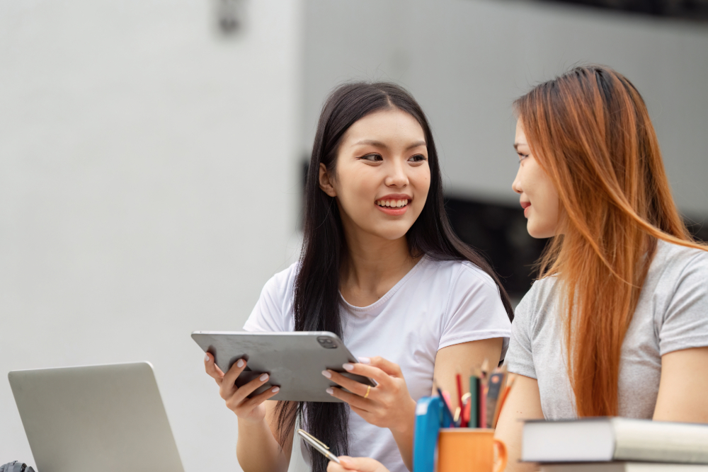 Two students sat working next to each other