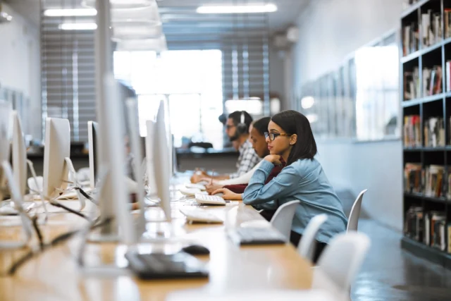 Students working on computers in library